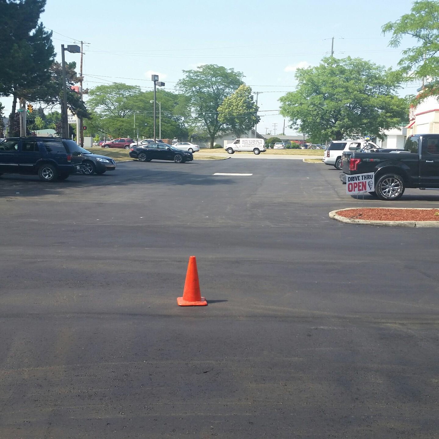 Asphalt paving machine laying surface treatment Central Virginia